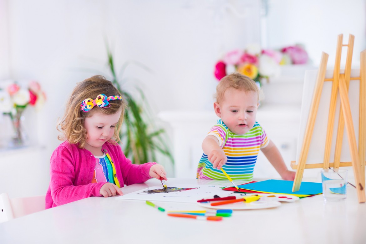 Happy children painting in nursery
