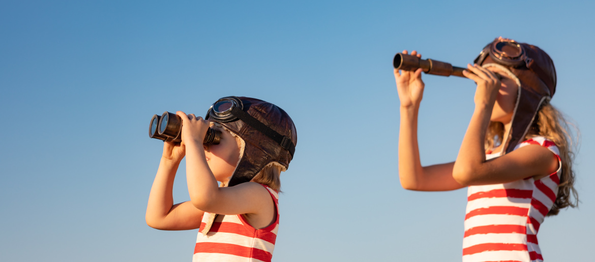 Young boy and girl looking through binoculars