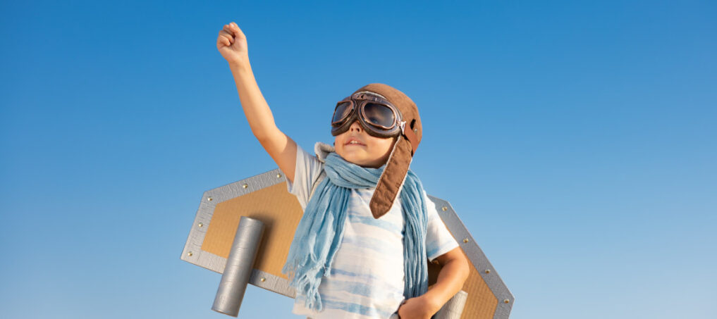 Happy young boy dressing up with rocket wings
