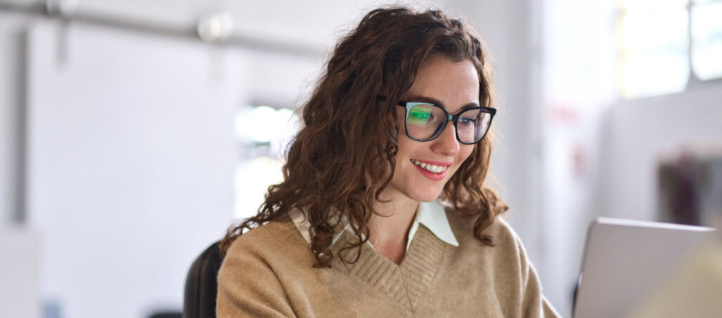 Young woman at laptop applying for job