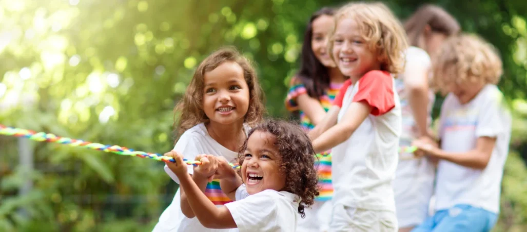 happy children playing tug of war