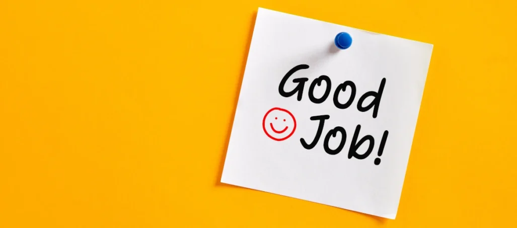 Handwritten good job note pinned to yellow board