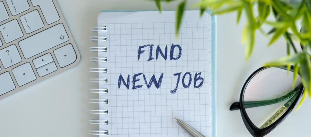 Laptop glasses and notepad with note to find new job